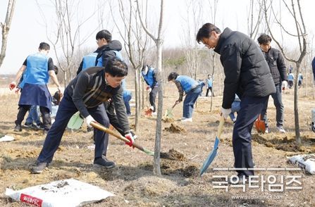 진교훈 강서구청장(왼쪽)이 20일(목) 세계 숲의 날을 맞아 열린 ‘나무돌봄 행사’에 참석해 나무에 비료를 주고 있다.